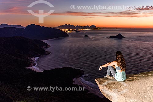  Woman observing the Rio de Janeiro waterfront from the Pedra do Telegrafo (Telegraph Stone) - Guaratiba Mountain during the dawn  - Rio de Janeiro city - Rio de Janeiro state (RJ) - Brazil