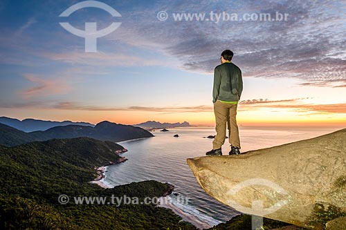  Man observing the Rio de Janeiro waterfront from the Pedra do Telegrafo (Telegraph Stone) - Guaratiba Mountain during the dawn  - Rio de Janeiro city - Rio de Janeiro state (RJ) - Brazil