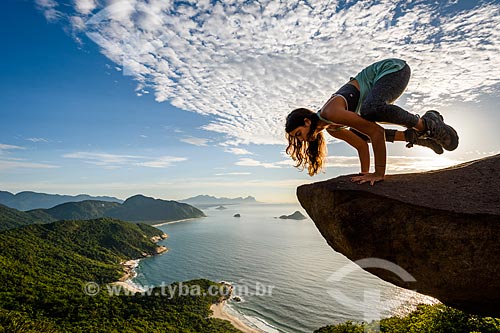  Woman practicing Yoga - Bakasana movement (crow) - Pedra do Telegrafo (Telegraph Stone) - Guaratiba Mountain  - Rio de Janeiro city - Rio de Janeiro state (RJ) - Brazil