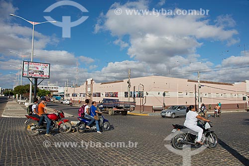  Transit of motorcycles with the City Public Market of Monteiro in the background  - Monteiro city - Paraiba state (PB) - Brazil