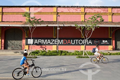  Children riding bicycles with the Utopia Warehouse (Warehouse 6 of Gamboa Pier) - Rio de Janeiro Port - in the background  - Rio de Janeiro city - Rio de Janeiro state (RJ) - Brazil