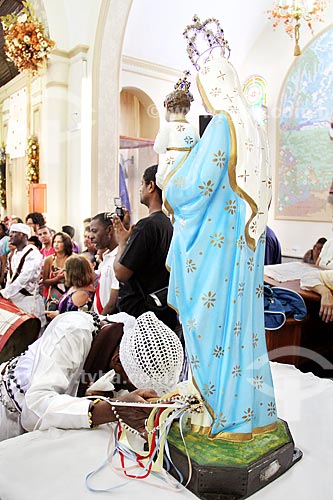  Congada participant praying to Our Lady of Rosary image inside of the Saint Benedict Church during the Festa de Sao Benedito (The Party of the Saint Benedict)  - Aparecida city - Sao Paulo state (SP) - Brazil