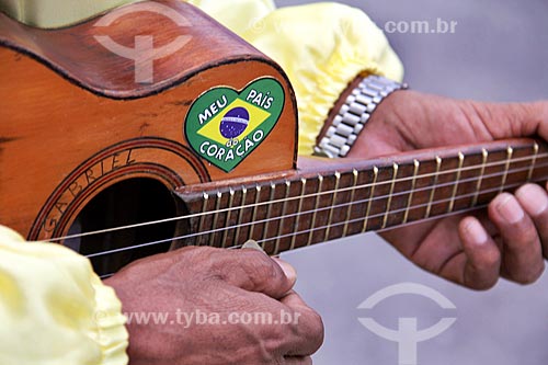  Detail of congada reveler playing small guitar during Party to Saint Benedict  - Aparecida city - Sao Paulo state (SP) - Brazil