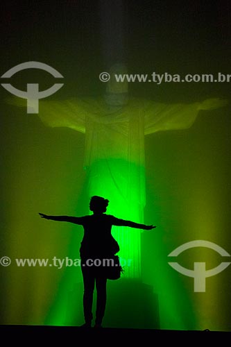  Woman silhouette opposite to Christ the Redeemer (1931) with special lighting - Green and Yellow  - Rio de Janeiro city - Rio de Janeiro state (RJ) - Brazil