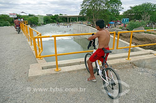  Boy observing the spillway pouring water into the Paraiba River - Project of Integration of Sao Francisco River  - Monteiro city - Paraiba state (PB) - Brazil