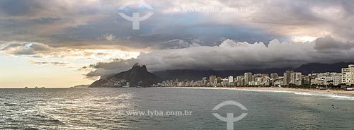  View of the sunset on a cloudy day - Arpoador Stone with the Ipanema Beach and Morro Dois Irmaos (Two Brothers Mountain) in the background  - Rio de Janeiro city - Rio de Janeiro state (RJ) - Brazil