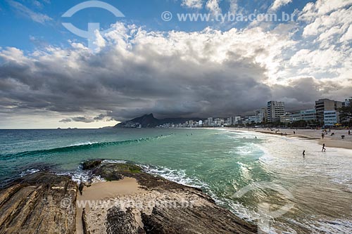  View of the sunset on a cloudy day - Arpoador Stone with the Ipanema Beach and Morro Dois Irmaos (Two Brothers Mountain) in the background  - Rio de Janeiro city - Rio de Janeiro state (RJ) - Brazil