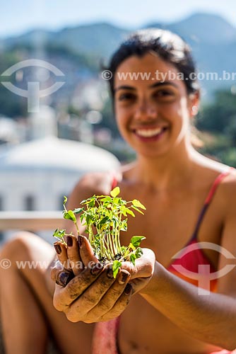  Woman holding a seedling of the lemon tree  - Rio de Janeiro city - Rio de Janeiro state (RJ) - Brazil