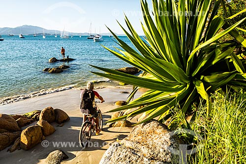  Fisherman and cyclist - Jurere Beach waterfront  - Florianopolis city - Santa Catarina state (SC) - Brazil