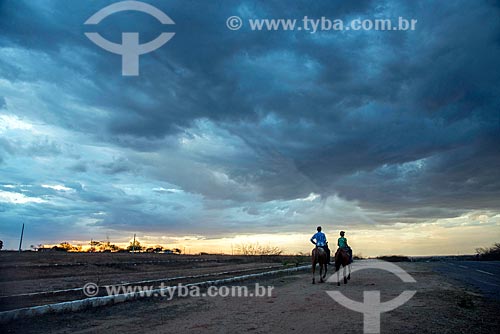  Dad and son riding during the sunset  - Mauriti city - Ceara state (CE) - Brazil