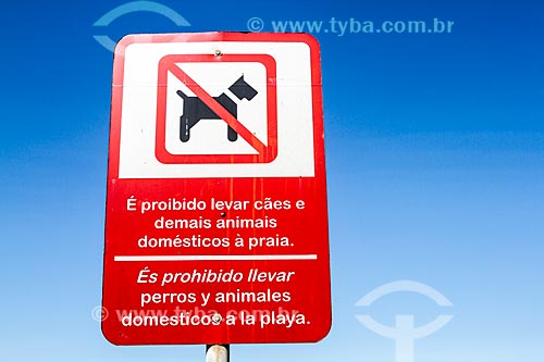  Bilingual plaque that say: It is forbidden to take dogs and other pets to the beach - Meia Beach (Half Beach)  - Itapema city - Santa Catarina state (SC) - Brazil