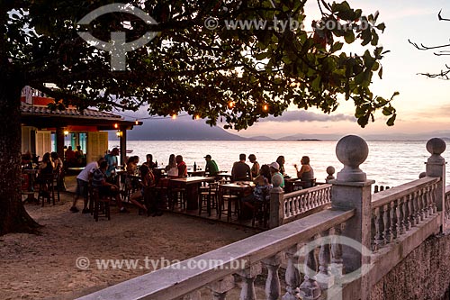  Bar tables on waterfront of Ribeirao da Ilha Beach during the sunset  - Florianopolis city - Santa Catarina state (SC) - Brazil