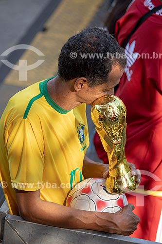  Detail of fan holding ball and replica of FIFA World Cup Trophy - Olympic Boulevard during the match between Brazil x Belgium - World cup 2018 - game in which Brazil was eliminated  - Rio de Janeiro city - Rio de Janeiro state (RJ) - Brazil