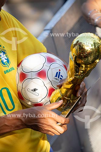  Detail of fan holding ball and replica of FIFA World Cup Trophy - Olympic Boulevard during the match between Brazil x Belgium - World cup 2018 - game in which Brazil was eliminated  - Rio de Janeiro city - Rio de Janeiro state (RJ) - Brazil