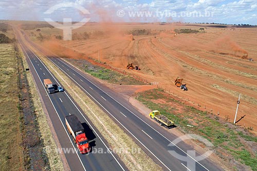  Picture taken with drone of the grass seed mechanized harvesting on the banks of the BR-365 highway  - Uberlandia city - Minas Gerais state (MG) - Brazil