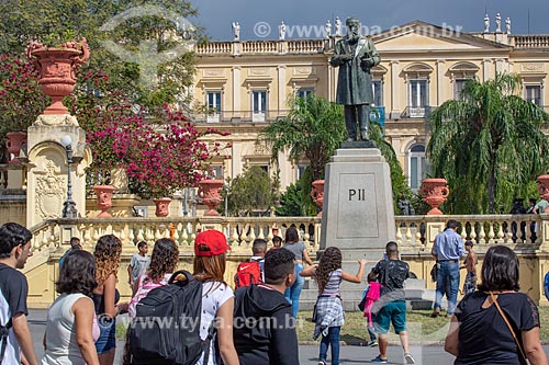  Public near to statue of Dom Pedro II (1925) with the National Museum - old Sao Cristovao Palace - in the background  - Rio de Janeiro city - Rio de Janeiro state (RJ) - Brazil