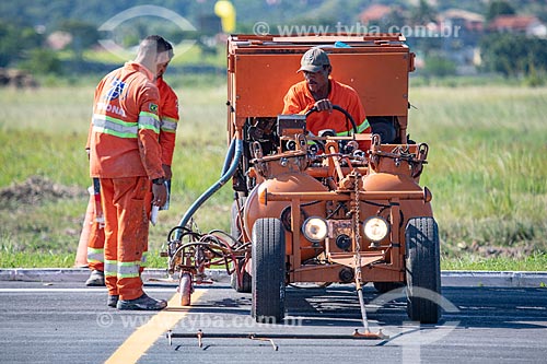  Labourers of the Municipality of Marica doing the road signaling paint - runway of the Laelio Baptista Airport - also known as Marica Airport  - Marica city - Rio de Janeiro state (RJ) - Brazil