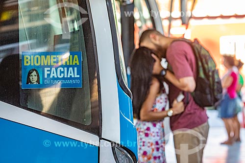  Sticker - informing the use of Facial Biometrics system in bus - People of Marica Bus Station - old Jacinto Luis Caetano Bus Terminal - with couple kissing in the background  - Marica city - Rio de Janeiro state (RJ) - Brazil