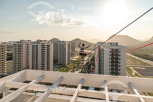  Practitioner of slackline between the buildings of Pura Island Village of Athletes - Residential Condominium where athletes stayed during the Olympic Games - Rio 2016 - during the sunset  - Rio de Janeiro city - Rio de Janeiro state (RJ) - Brazil