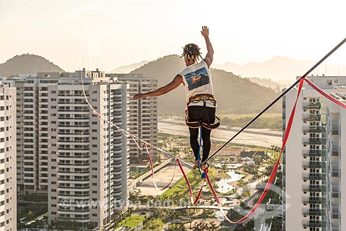  Practitioner of slackline between the buildings of Pura Island Village of Athletes - Residential Condominium where athletes stayed during the Olympic Games - Rio 2016 - during the sunset  - Rio de Janeiro city - Rio de Janeiro state (RJ) - Brazil