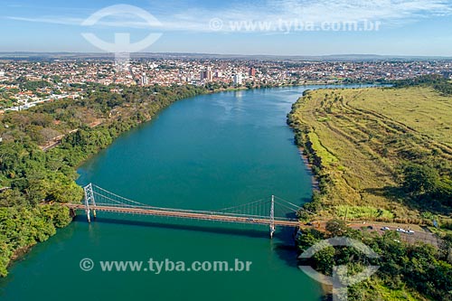  Picture taken with drone of the Affonso Penna Suspension Bridge (1909) over of Paranaiba River with the Itumbiara city - to the left - and Arapora city - to the right - natural boundary between Goias and Minas Gerais states  - Itumbiara city - Goias state (GO) - Brazil