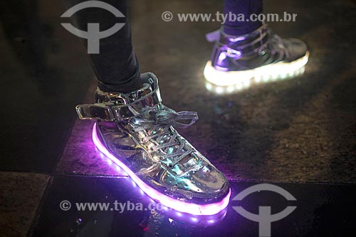  Detail of lighted tennis shoes during parade of the my light is led carnival street troup - Marechal Ancora Square  - Rio de Janeiro city - Rio de Janeiro state (RJ) - Brazil