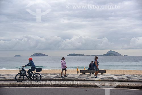  Cyclist and pedestrians in bike lane - Leblon Beach waterfront with the Natural Monument of Cagarras Island in the background  - Rio de Janeiro city - Rio de Janeiro state (RJ) - Brazil
