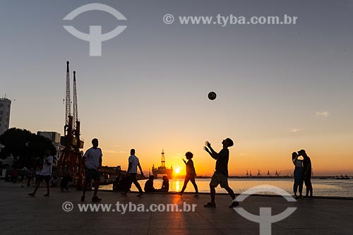  Young playing soccer - Maua Square with petroleum platform in the background during the sunset  - Rio de Janeiro city - Rio de Janeiro state (RJ) - Brazil