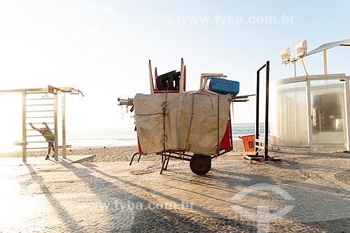  Detail of cargo trolley - man carrying a cart - with beach chairs - Copacabana Beach waterfront during the dawn  - Rio de Janeiro city - Rio de Janeiro state (RJ) - Brazil
