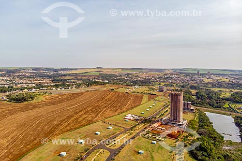  Picture taken with drone of the canavial with the Olhos DAgua (Water Eyes) Park - to the left - and residential condominium  - Ribeirao Preto city - Sao Paulo state (SP) - Brazil