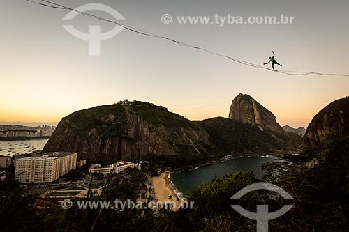  Practitioner of slackline with the Sugarloaf in the background during the sunset  - Rio de Janeiro city - Rio de Janeiro state (RJ) - Brazil