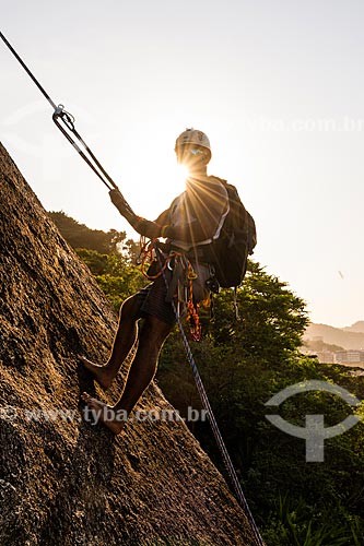  Detail of climber during the climbing to the Babilonia Mountain (Babylon Mountain) during the sunset  - Rio de Janeiro city - Rio de Janeiro state (RJ) - Brazil