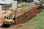  Withdrawal of earth with backhoe on street to be paved  - Sao Jose do Rio Preto city - Sao Paulo state (SP) - Brazil