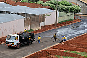  Worker spreading tar on street being paved  - Sao Jose do Rio Preto city - Sao Paulo state (SP) - Brazil