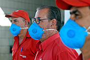  Gas station attendants working at a gas station and wearing a mask because of the Coronavirus Crisis  - Mirassol city - Sao Paulo state (SP) - Brazil