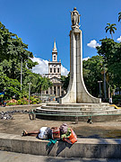  Homeless sleeping in the fountain of the Largo do Machado Square with the Matriz Church of Nossa Senhora da Gloria (1872) in the background  - Rio de Janeiro city - Rio de Janeiro state (RJ) - Brazil