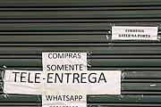  Store front sign stating that it is only working by tele-delivery - Coronavirus Crisis  - Porto Alegre city - Rio Grande do Sul state (RS) - Brazil