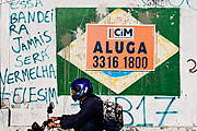  Motorcyclist passes in front of the sign suggesting that Brazil is for rent - Coronavirus Crisis  - Porto Alegre city - Rio Grande do Sul state (RS) - Brazil