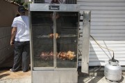Roasted chicken for sale on the sidewalk store - Roasted in a pan with canister gas - Pancas city - Espirito Santo state (ES) - Brazil