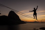 Practitioner of slackline with the Sugarloaf in the background at dawn - Rio de Janeiro city - Rio de Janeiro state (RJ) - Brazil