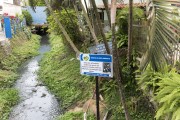 Stream with educational sign of waste and sewage disposal - Santa Maria de Jetiba city - Espirito Santo state (ES) - Brazil