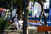 Man sitting on park bench during coronavirus crisis - Porto Alegre city - Rio Grande do Sul state (RS) - Brazil