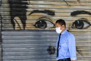 Man wearing mask while walking down the street - Coronavirus Crisis  - Porto Alegre city - Rio Grande do Sul state (RS) - Brazil