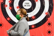Woman wearing mask while walking down the street - Coronavirus Crisis  - Porto Alegre city - Rio Grande do Sul state (RS) - Brazil