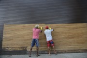 Workers scraping wood paint - Sao Paulo city - Sao Paulo state (SP) - Brazil