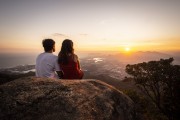 Couple watching the sunset on Bico do Papagaio Mountain - Tijuca National Park - Rio de Janeiro city - Rio de Janeiro state (RJ) - Brazil