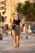 Woman with protective mask against Covid-19 walking on the Copacabana Beach boardwalk - Rio de Janeiro city - Rio de Janeiro state (RJ) - Brazil