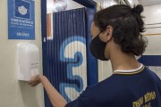 Student wearing a mask and hand washing with alcohol gel at the entrance to the state high school classroom - Sao Paulo city - Sao Paulo state (SP) - Brazil