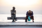 Homeless man sitting on the bench next to the statue of the poet Carlos Drummond de Andrade - Rio de Janeiro city - Rio de Janeiro state (RJ) - Brazil
