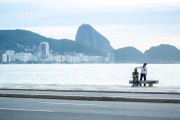 Woman petting the statue of the poet Carlos Drummond de Andrade on Copacabana Beach - Rio de Janeiro city - Rio de Janeiro state (RJ) - Brazil